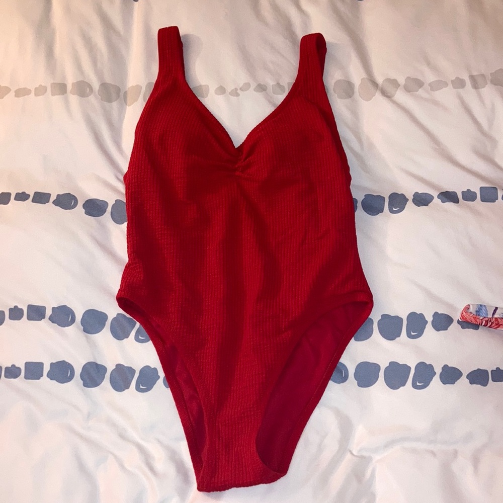 Women one piece red bathing suit.